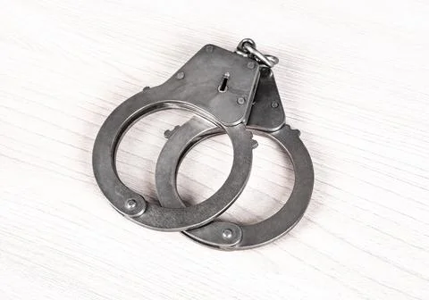 Handcuffs on the Table Stock Photos