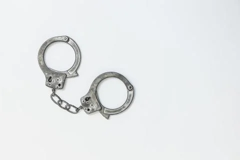 Handcuffs on white background. copyspace Stock Photos