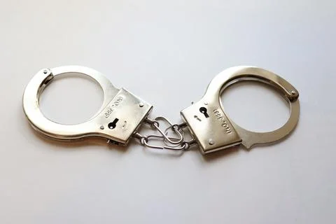 Handcuffs on a white background Stock Photos