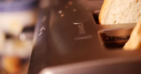 Handed pressing toaster lever down to make toast for breakfast  Vidéo 150607223