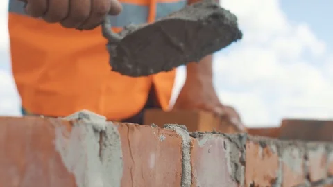 Handed shot of Bricklayer builds wall Video stock 92072185