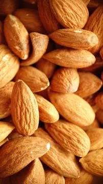 A handful of almonds in close-up selective focus Stock Photos