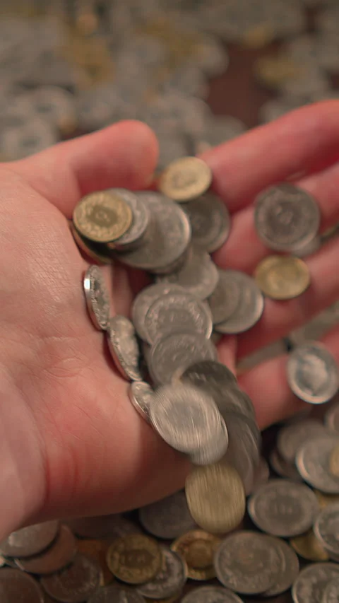 A Handful of Coins Understanding Wealth and Value in Personal Savings and Stock Footage 296005103
