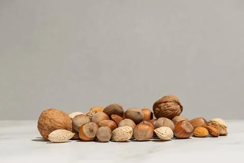 A handful of different nuts on a gray background Stock Photos