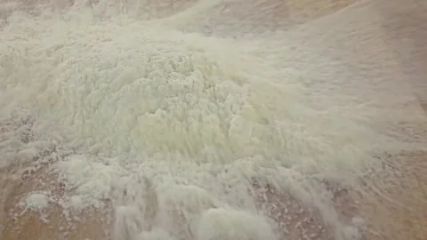 Handful of flour falls on table. Slow motion, top view Vidéo 75487766