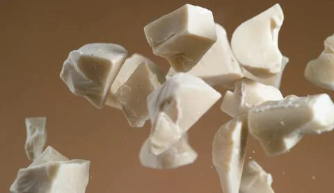 A handful of irregularly shaped, off-white chunks of a substance Stock Photos