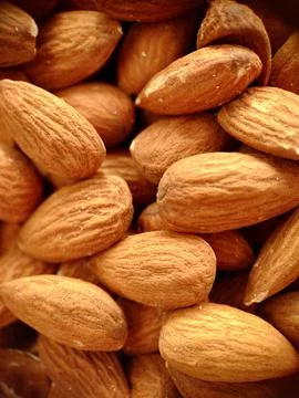 A handful of large almonds close-up selective focus Stock Photos