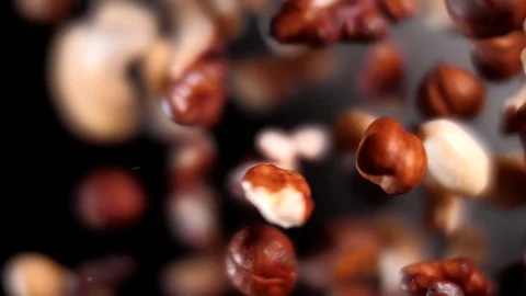 A handful of nuts of all kinds fly in super slow motion. Macro shooting. Stock Footage 109152046