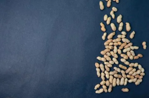 Handful peanuts on a dark background, top view with place for text. Stock Photos