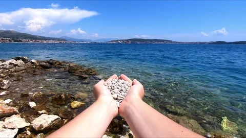 A handful of pebbles on the beach Stock Footage 274936891