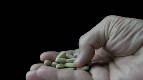 A handful of pills in a hand. Stock Footage 155238378