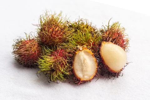 Handful rambutan tropical fruit with white core on a white isolated backgroun Stock Photos