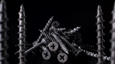 A handful of self-tapping screws are on the table, and the camera moves smoothly Stock Footage 144334699