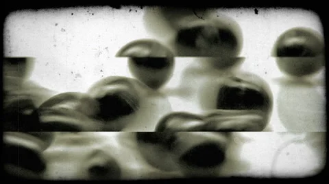 A handful of small black objects roll into view. Vintage stylized video clip. Video stock 52707369