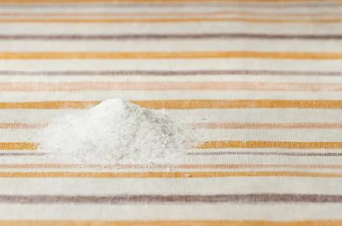 A handful of table salt on the kitchen table. Stock Photos