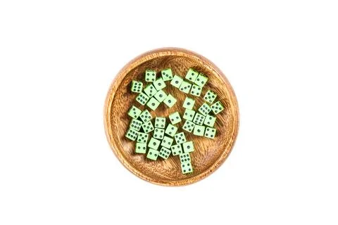 Handful of tiny green neon dice in a wooden cup isolated over white Stock Photos