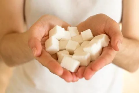 Handfull of sugar cubes  Stock Photos