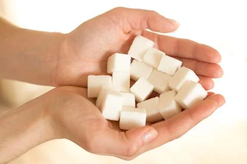 Handfull of sugar cubes  Stock Photos