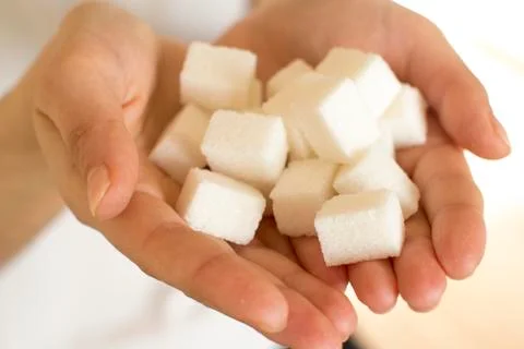 Handfull of sugar cubes  Stock Photos