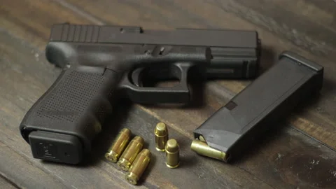 Handgun and ammunition on table Stock Footage 143977944