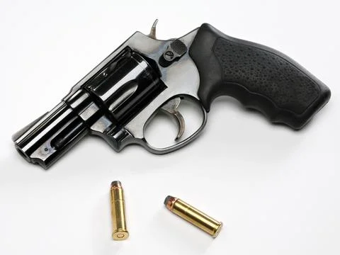 Handgun with bullets on white background Stock Photos