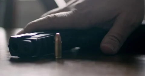 Handgun Picked Up Close Up | Bright Backlight Stock Footage 229489823