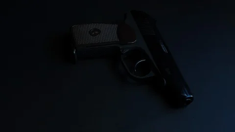 Handgun rotates on a platform black background Stock Footage 127949853