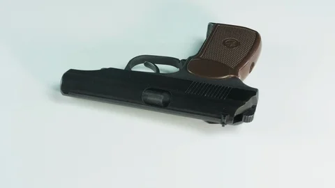 Handgun rotates on a platform white background Stock Footage 127950034