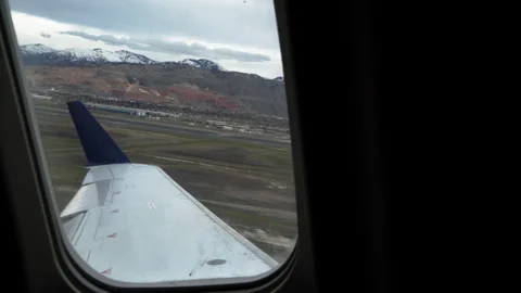 Handheld Airplane Window Takeoff Snow Covered Mountains View Stock Footage 335781916