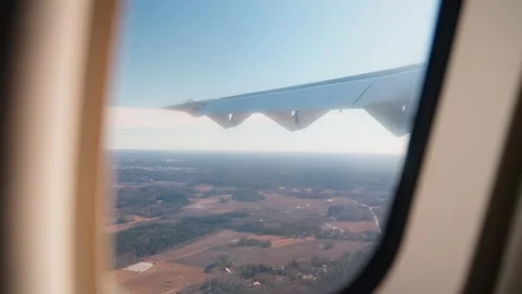 Handheld airplane-window view during rough flight, with visible wing shake Stock Footage 333655556