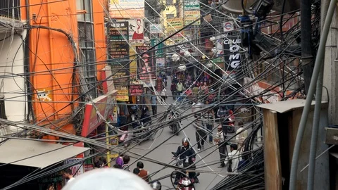 Handheld busy intersection central Kathmandu Nepal electrical lines crossing Stock Footage 119349526
