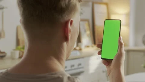 Handheld Camera: Back View of Blond Man Holding Chroma Key Green Screen Видео 171945217