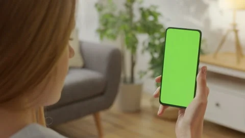 Handheld Camera: Back View of Blond Man Holding Chroma Key Green Screen Stock Footage 171945402