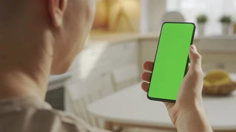 Handheld Camera: Back View of Blond Man Holding Chroma Key Green Screen Stock Footage 205573542