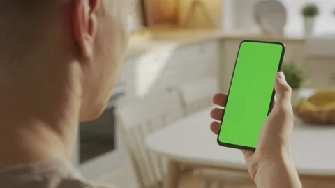 Handheld Camera: Back View of Blond Man Holding Chroma Key Green Screen Stock Footage 205575073