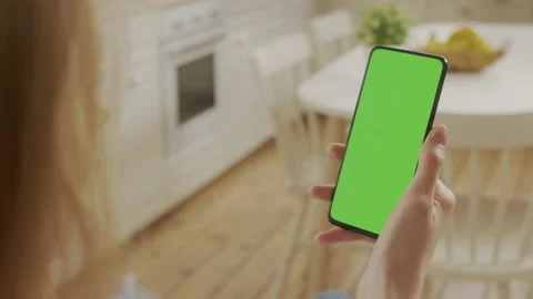 Handheld Camera: Back View of Blond Woman Holding Chroma Key Green Screen Stock Footage 205577621