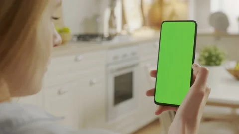 Handheld Camera: Back View of Blond Woman Holding Chroma Key Green Screen Stock Footage 205577832