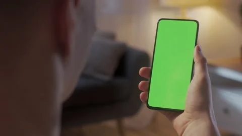 Handheld Camera: Back View of Blond Man Holding Chroma Key Green Screen Stock Footage 206018016