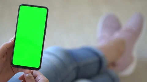 Handheld Camera: Back view of brunette holding chroma key green screen Stock Footage 139950307