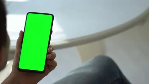 Handheld Camera: Back view of brunette holding chroma key green screen Stock Footage 139950326