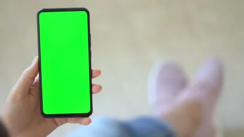Handheld Camera: Back view of brunette holding chroma key green screen Stock Footage 140072152