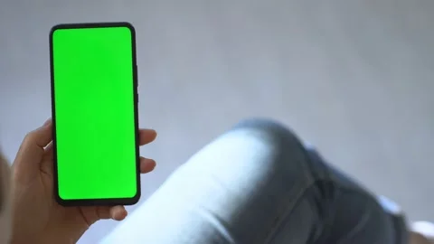 Handheld Camera: Back view of brunette holding chroma key green screen Stock Footage 140156759