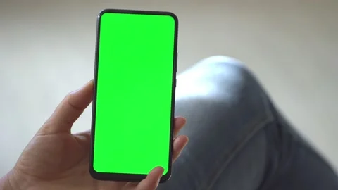 Handheld Camera: Back view of brunette holding chroma key green screen Stock Footage 140527643