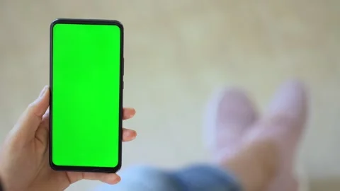 Handheld Camera: Back view of brunette holding chroma key green screen Stock Footage 140947394