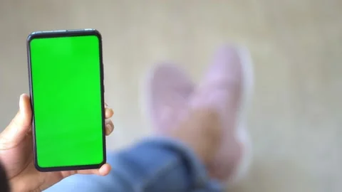 Handheld Camera: Back view of brunette holding chroma key green screen Stock Footage 141204929