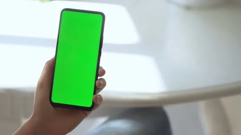 Handheld Camera: Back view of brunette holding chroma key green screen Stock Footage 141297735