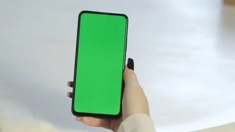 Handheld Camera: Back View of Brunette woman Holding Chroma Key Green Screen Stock Footage 201315389