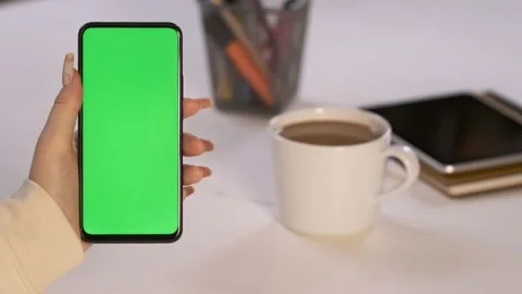 Handheld Camera: Back View of Brunette woman Holding Chroma Key Green Screen Video stock 202203095