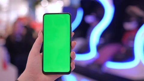 Handheld Camera: back view of brunette holding chroma key green screen Stock Footage 246321836
