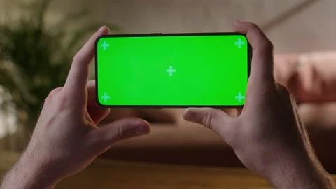Handheld Camera: Back View of Man at Phone with Green Screen for Copy Space Stock Footage 165291728